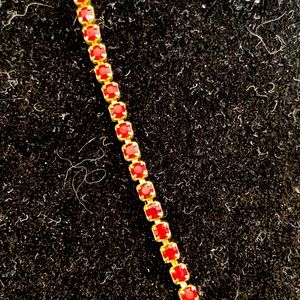 Thin gold tone and imitation ruby bracelet